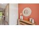 A welcoming entryway with a decorative mirror and console table against an accent wall at 17469 Spanish Oak Loop, Land O Lakes, FL 34638