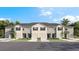 Charming townhomes featuring individual garages and light exteriors perfect for modern living at 17469 Spanish Oak Loop, Land O Lakes, FL 34638