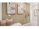 A hallway with decorative artwork, a coat rack, and a comfortable bench with decorative pillows at 17469 Spanish Oak Loop, Land O Lakes, FL 34638
