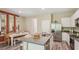 Open-concept kitchen featuring an island, stainless appliances, and a view of the dining area at 17469 Spanish Oak Loop, Land O Lakes, FL 34638