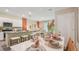 An open-concept kitchen and dining area with modern fixtures and a stylish dining table setting at 17469 Spanish Oak Loop, Land O Lakes, FL 34638