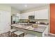 A modern kitchen with stainless steel appliances, white cabinetry, and an island with barstool seating at 17469 Spanish Oak Loop, Land O Lakes, FL 34638