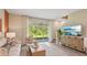 Bright living room with large sliding doors, offering scenic outdoor views and plenty of natural light at 17469 Spanish Oak Loop, Land O Lakes, FL 34638