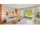 Bright living room boasts ample seating and natural light through sliding glass doors at 17477 Spanish Oak Loop, Land O Lakes, FL 34638