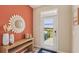 Entryway with decoratively framed mirror, console table, and view of the front door and yard at 17481 Spanish Oak Loop, Land O Lakes, FL 34638