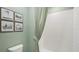 Bathroom with tiled shower, green walls, and neutral decor at 17491 Spanish Oak Loop, Land O Lakes, FL 34638