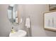 Chic powder room features a round mirror, pedestal sink, and nature-inspired decor at 17491 Spanish Oak Loop, Land O Lakes, FL 34638