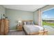 Bedroom featuring a comfortable bed and a large window at 17491 Spanish Oak Loop, Land O Lakes, FL 34638
