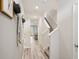 Inviting hallway with hardwood flooring, a staircase, and coat hooks at 17491 Spanish Oak Loop, Land O Lakes, FL 34638