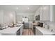 Well-equipped kitchen with stainless steel appliances, stone countertops, and gray shaker cabinets at 17491 Spanish Oak Loop, Land O Lakes, FL 34638