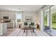 Bright living room with stylish decor, hardwood flooring, and a sliding door to the patio at 17491 Spanish Oak Loop, Land O Lakes, FL 34638