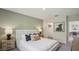 Bedroom featuring plush bedding, side tables, and a walk in closet at 17491 Spanish Oak Loop, Land O Lakes, FL 34638