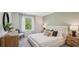 Cozy bedroom with plush bedding, side tables, and view of the backyard at 17491 Spanish Oak Loop, Land O Lakes, FL 34638