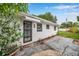 The back door of this home features a security door and a small awning at 209 Se Jefferson N Cir, St Petersburg, FL 33702