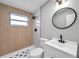 Modern bathroom with stylish fixtures, white tile, and walk-in shower at 209 Se Jefferson N Cir, St Petersburg, FL 33702