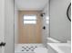 Modern bathroom with walk-in shower, white tile, and updated vanity at 209 Se Jefferson N Cir, St Petersburg, FL 33702