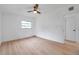 This bedroom features a window, a ceiling fan, and light wood-look floors at 209 Se Jefferson N Cir, St Petersburg, FL 33702
