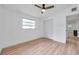 This bedroom features a window, a closet, and light wood-look floors at 209 Se Jefferson N Cir, St Petersburg, FL 33702