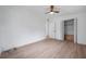 This bedroom features a closet, a ceiling fan, and light wood-look floors at 209 Se Jefferson N Cir, St Petersburg, FL 33702