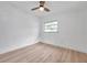 This bedroom features a window, a ceiling fan, and light wood-look floors at 209 Se Jefferson N Cir, St Petersburg, FL 33702