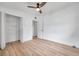 This bedroom features a closet, a ceiling fan, and light wood-look floors at 209 Se Jefferson N Cir, St Petersburg, FL 33702