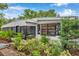 Charming home exterior with lush landscaping and unique window details at 209 Se Jefferson N Cir, St Petersburg, FL 33702