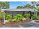Charming home featuring a screened-in porch and neat landscaping with vibrant palm trees at 209 Se Jefferson N Cir, St Petersburg, FL 33702