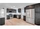 Modern kitchen with stainless steel appliances and stylish dark cabinetry at 209 Se Jefferson N Cir, St Petersburg, FL 33702