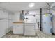 Well-lit laundry room with washer, dryer, and patterned tile flooring at 209 Se Jefferson N Cir, St Petersburg, FL 33702