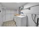 Bright laundry room featuring patterned floors and a washing machine at 209 Se Jefferson N Cir, St Petersburg, FL 33702