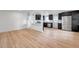 Bright, open-concept living and kitchen space with light wood floors at 209 Se Jefferson N Cir, St Petersburg, FL 33702