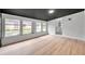 Sunroom with black ceiling, wood floors, and lots of windows at 209 Se Jefferson N Cir, St Petersburg, FL 33702