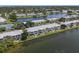 Aerial view of lakeside condos featuring mature trees and lush landscaping in a waterfront setting at 225 Pompano Se Dr # D, St Petersburg, FL 33705