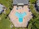 Aerial view of a community pool with lounge chairs and tables around it at 225 Pompano Se Dr # D, St Petersburg, FL 33705