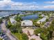 Aerial view of a beautiful community with a pool, clubhouse, and lake views at 225 Pompano Se Dr # D, St Petersburg, FL 33705