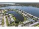 Scenic aerial view of a community with waterfront condos, a lake, and tennis courts at 225 Pompano Se Dr # D, St Petersburg, FL 33705