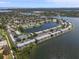 Panoramic aerial shot showcasing a community with lake, tennis courts, and lush landscaping at 225 Pompano Se Dr # D, St Petersburg, FL 33705