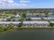 Aerial view of the community featuring lush landscaping, a lake, and tennis courts at 225 Pompano Se Dr # D, St Petersburg, FL 33705