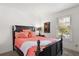 Bedroom featuring a dark wood bed frame and a window with blinds for privacy and natural light at 225 Pompano Se Dr # D, St Petersburg, FL 33705