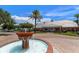 Community clubhouse with a water fountain in the foreground and beautiful landscaping at 225 Pompano Se Dr # D, St Petersburg, FL 33705
