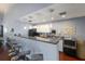 Stylish communal kitchen with modern bar seating, black appliances, and ample counter space at 225 Pompano Se Dr # D, St Petersburg, FL 33705