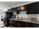 The kitchen includes granite countertops, dark cabinetry, and stainless steel appliances at 225 Pompano Se Dr # D, St Petersburg, FL 33705