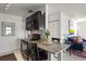 Open kitchen with granite countertops, black appliances, an eat-in area, and a view of the living space at 225 Pompano Se Dr # D, St Petersburg, FL 33705