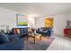 Comfortable living room with colorful artwork, couches, and a bright, welcoming atmosphere at 225 Pompano Se Dr # D, St Petersburg, FL 33705