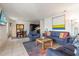 Cozy living room showcases stylish furniture, a colorful rug, and a view into the adjacent dining and kitchen areas at 225 Pompano Se Dr # D, St Petersburg, FL 33705