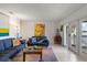 Bright living room with tile floors, comfortable seating, and a water view from the balcony at 225 Pompano Se Dr # D, St Petersburg, FL 33705