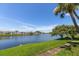 Community with a picturesque lake view framed by lush greenery and clear blue sky at 225 Pompano Se Dr # D, St Petersburg, FL 33705
