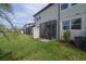 Well-manicured backyard with a screened-in patio area at 2469 Stapleford Pl, Wesley Chapel, FL 33543