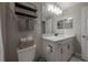 Bright bathroom featuring a single sink vanity, a mirror, and open shelving and toilet at 2469 Stapleford Pl, Wesley Chapel, FL 33543
