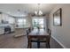 Dining area with a wooden table, natural light, and a view of the kitchen and backyard at 2469 Stapleford Pl, Wesley Chapel, FL 33543